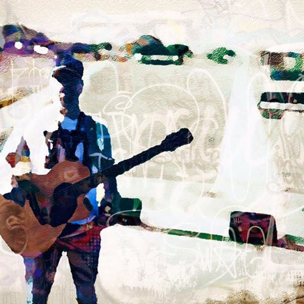 Nathan Smith performing on guitar at a venue