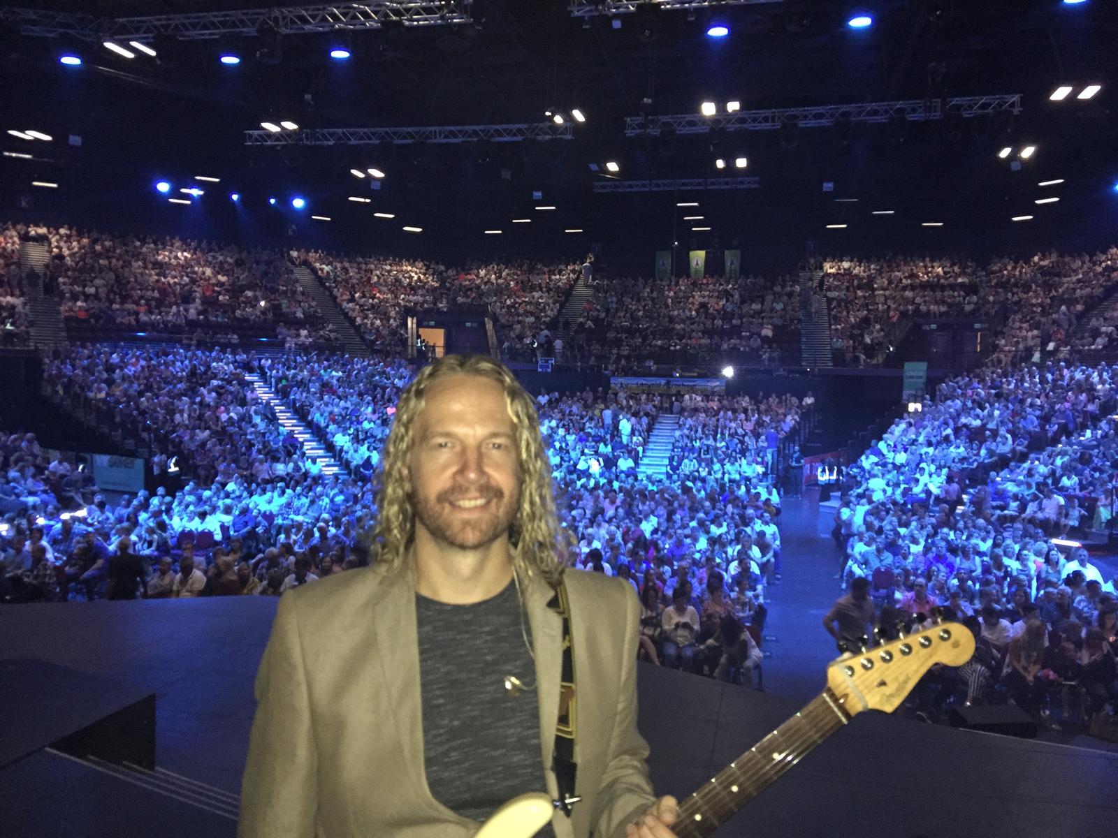 Nathan Smith on stage in front of a large crowd